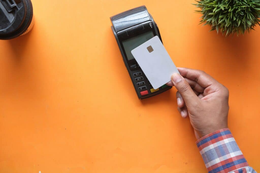 Man tapping bank card on card reader