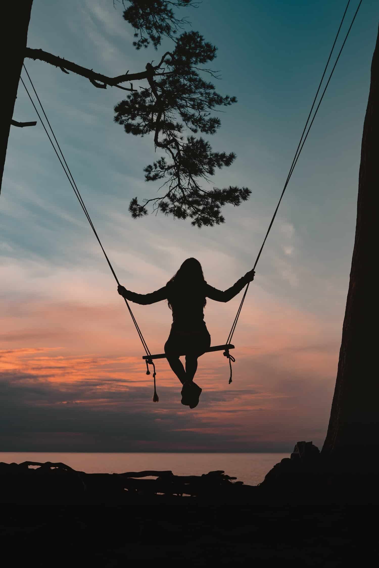 Person on swing looking over the horizon
