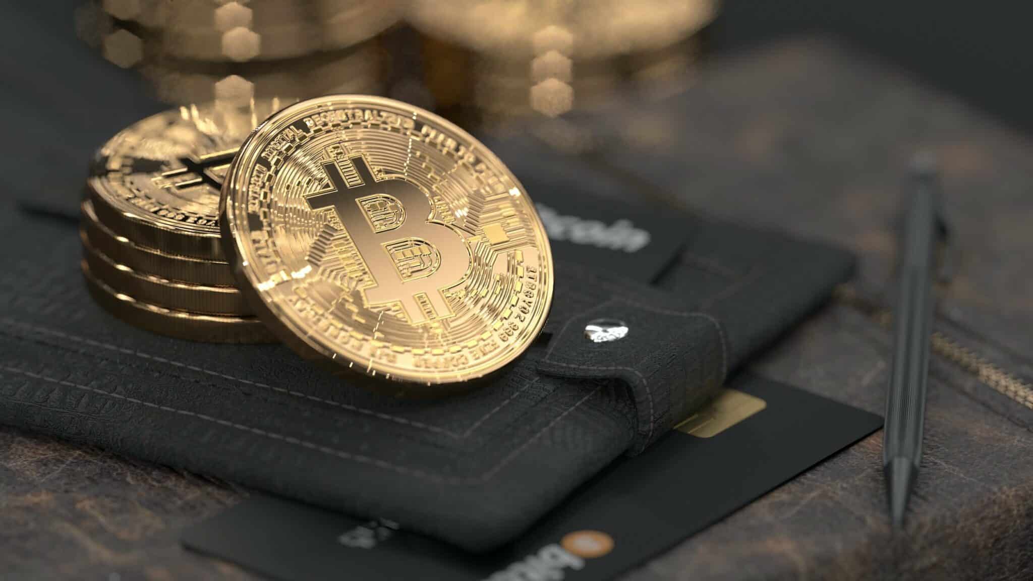 Pile of physical Bitcoins sitting on a wallet