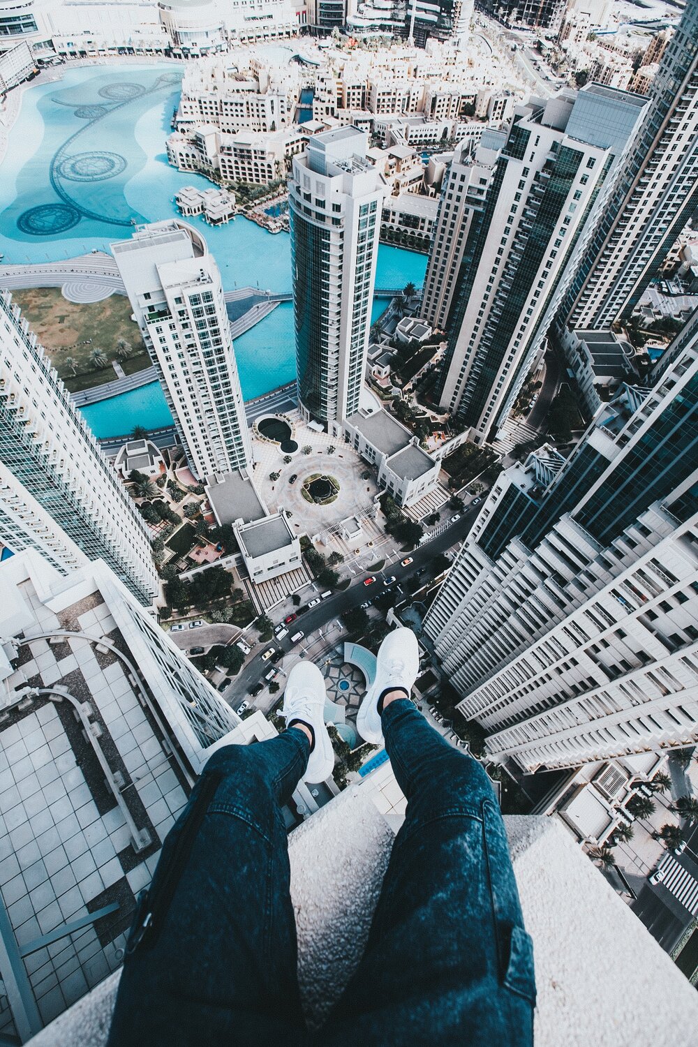 Person sitting on the top of a skyscraper