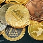 A close-up of various cryptocurrency coins including Bitcoin, Ethereum, and altcoins, symbolising digital asset diversity and crypto investment opportunities – featured by The Investors Centre.”