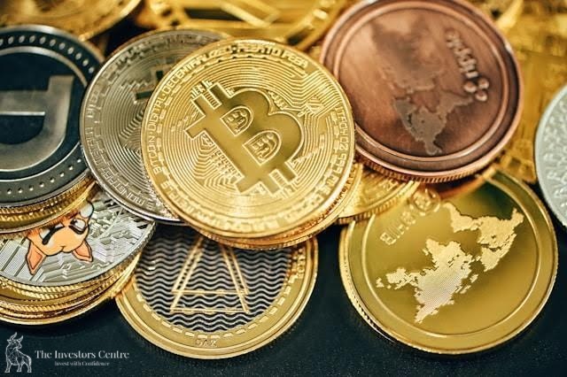 A close-up of various cryptocurrency coins including Bitcoin, Ethereum, and altcoins, symbolising digital asset diversity and crypto investment opportunities – featured by The Investors Centre.”