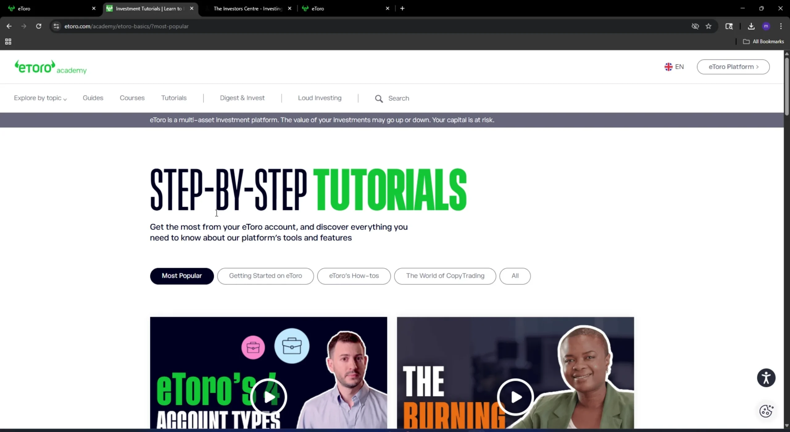 eToro Academy tutorials page showing step-by-step investment guides and educational videos
